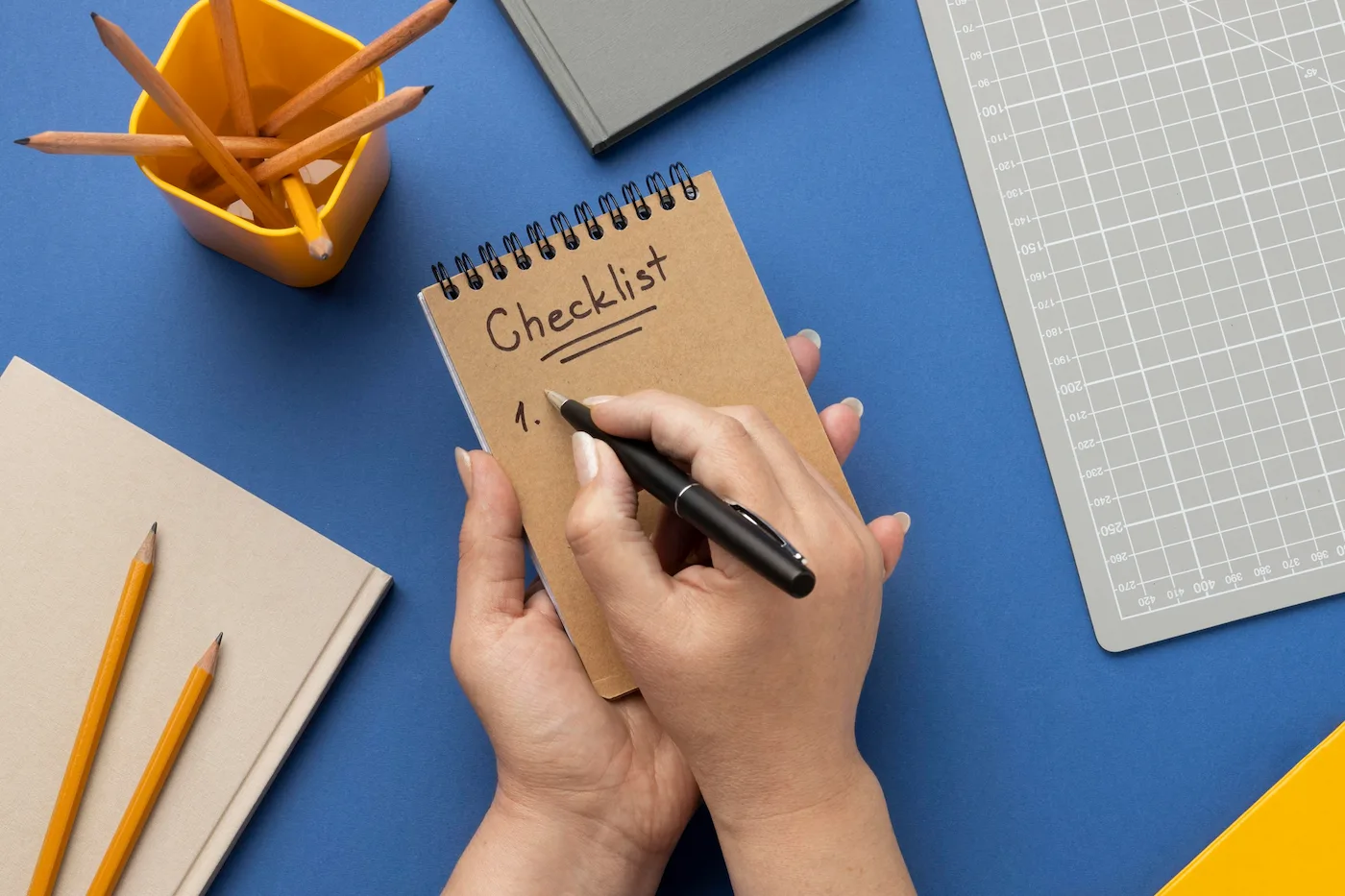 checklist and laptop on a desk for hiring a copywriter