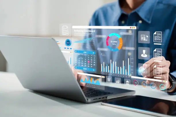 Analyst using a laptop with an SEO analytics dashboard and charts